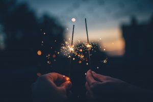 two people holding sparkers