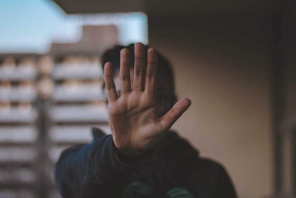 man holding hand in stop