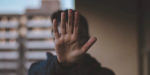 man holding hand in stop
